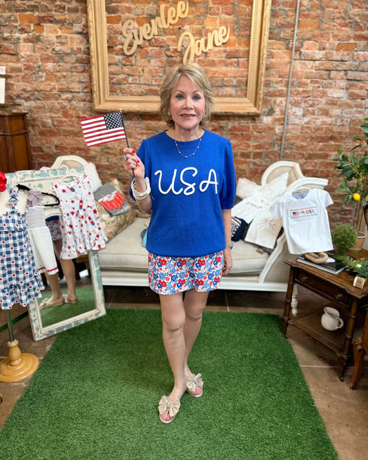 Blue USA Pop Up Letter Sweater Knit Top; available in S-XL. Features bold lettering and a cozy knit texture.