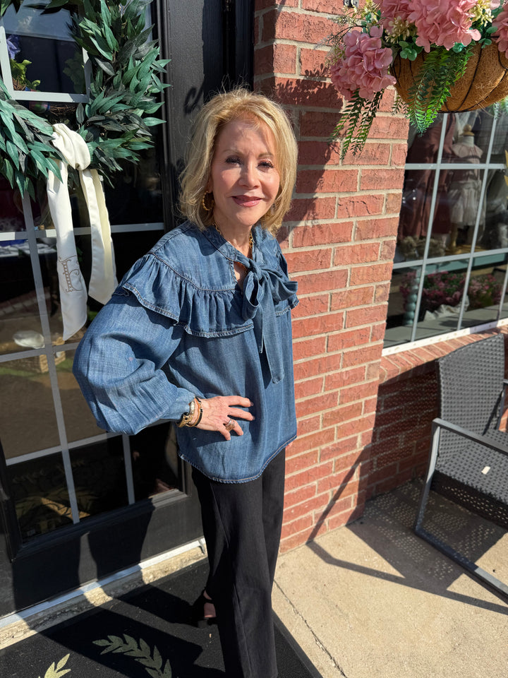 Denim Bow Top in blue with a bow detail; available in sizes XS–XL.