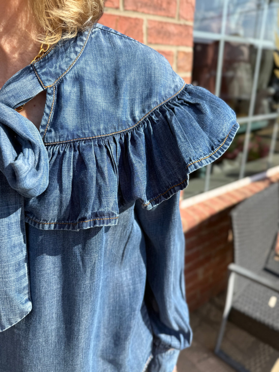 Blue Tencel Denim Bow Top featuring a stylish bow detail; available in sizes XS–XL.