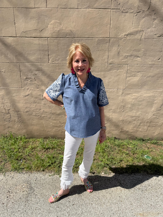 Denim Floral Top with patterned sleeves; available in sizes XS–XL.