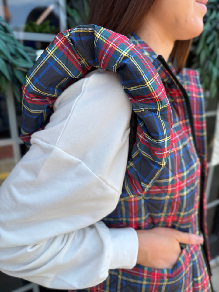 Plaid Tidings Puffer vest with front pockets, available in sizes XS–XL.