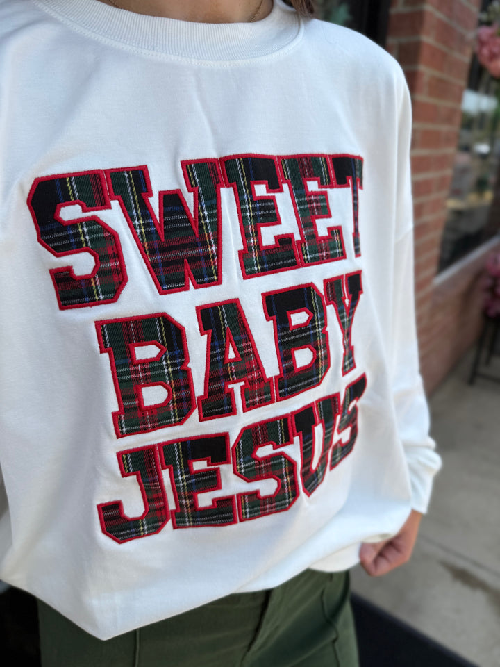 White long-sleeve Sweet Baby Jesus crew neck sweatshirt with plaid “SWEET BABY JESUS” lettering and red outline.