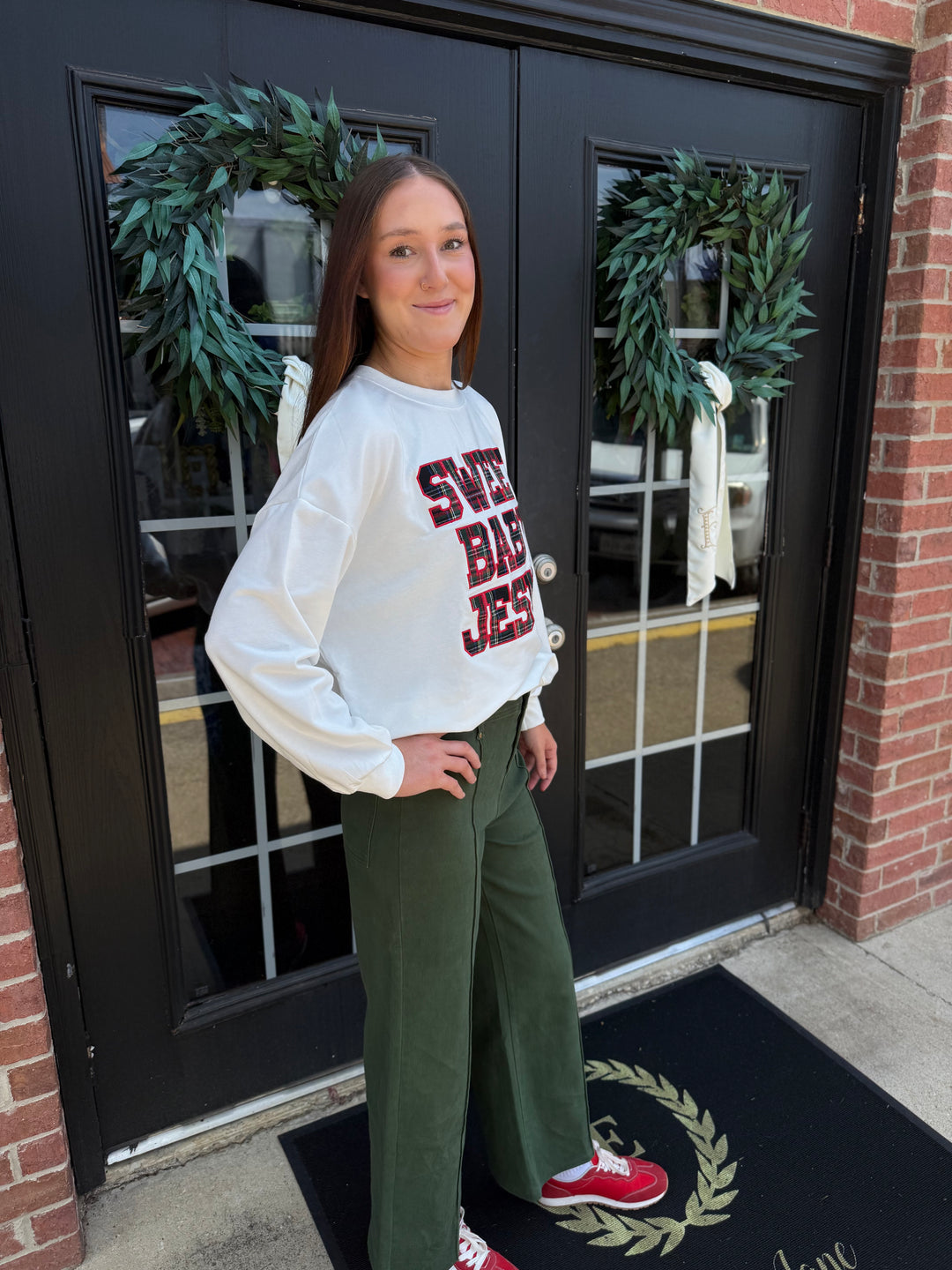 White Sweet Baby Jesus crew neck sweatshirt with red and black plaid lettering. Available in all sizes.