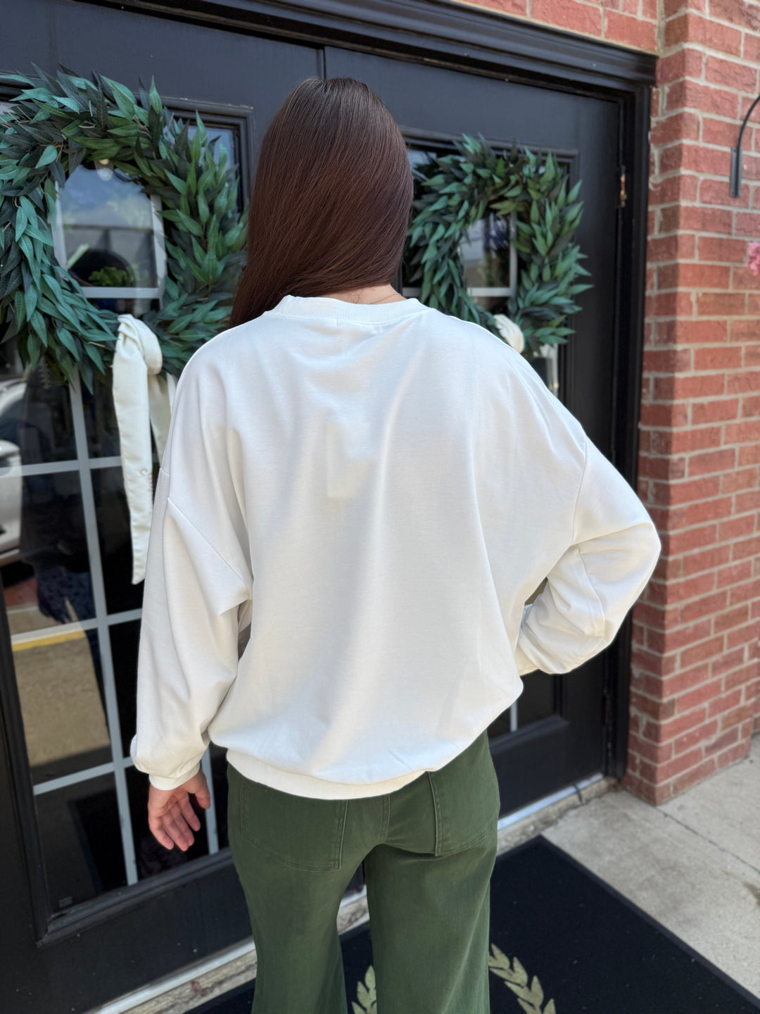 White long-sleeve Sweet Baby Jesus crew neck sweatshirt with plaid lettering. Available in all sizes.