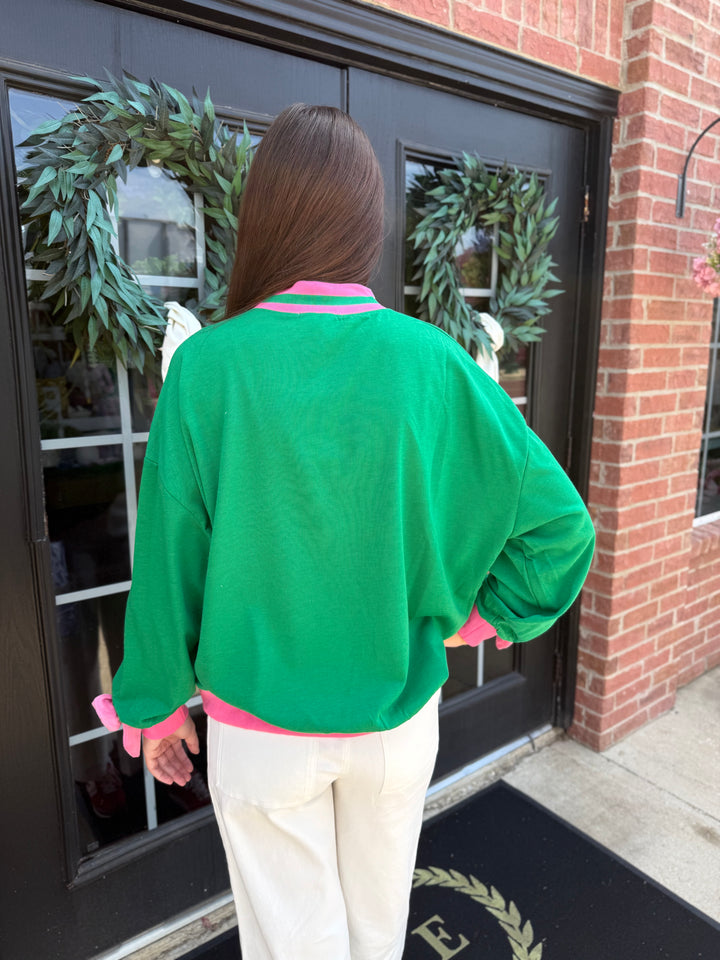 Oh What Fun Mock Neck top in green with pink trim at the collar, cuffs, and hem. Available in multiple sizes.