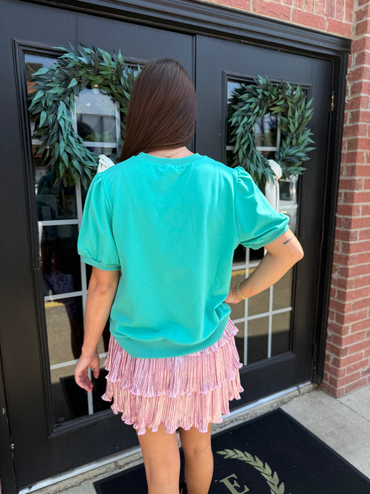 Teal Cheetah Puff Sleeve Tee with relaxed fit, puff shoulders, crew neckline, and glitter cheetah print. Available in multiple sizes.