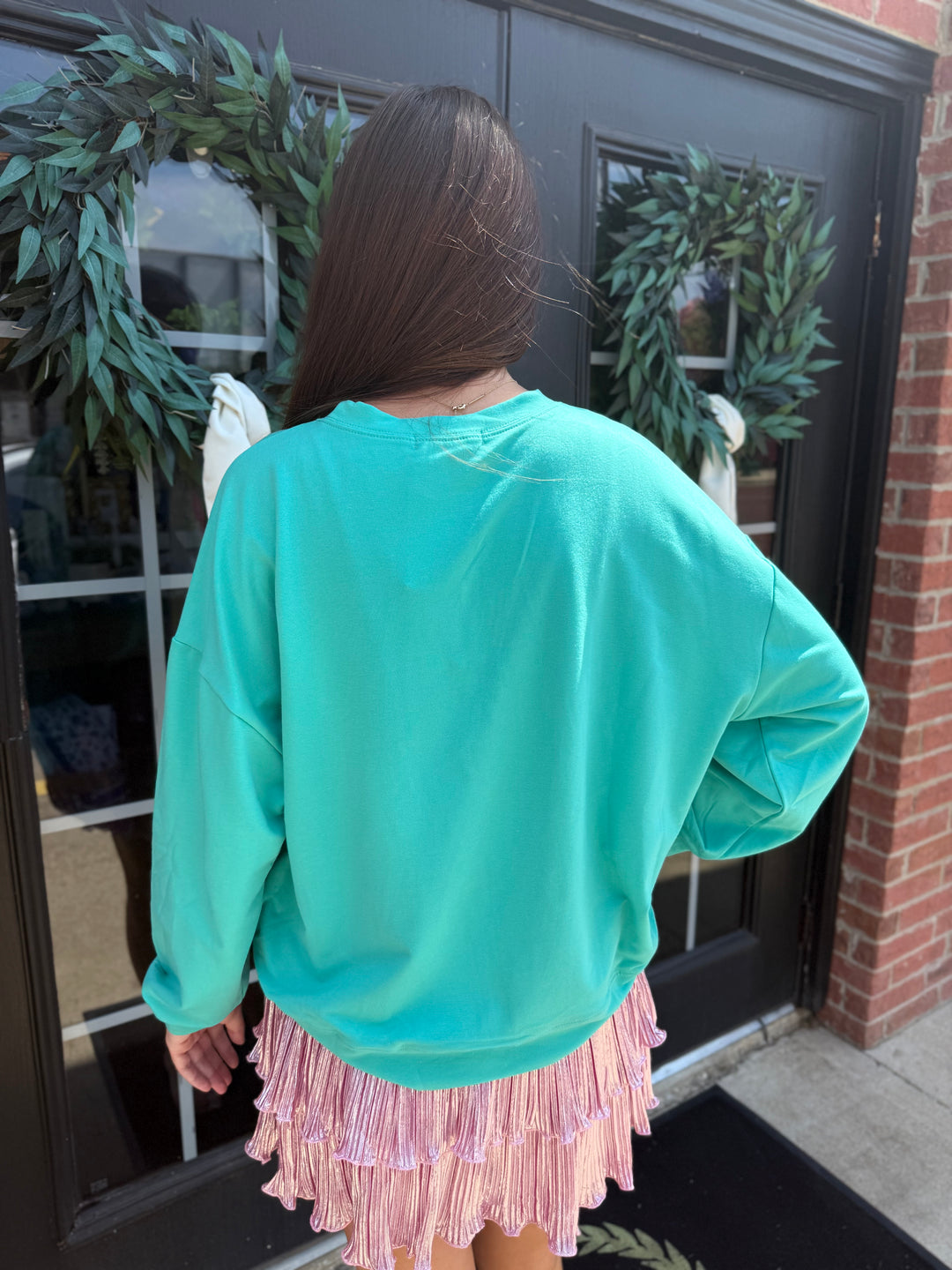 Bright turquoise long-sleeve gemstone Christmas tree sweatshirt with pastel sequins.