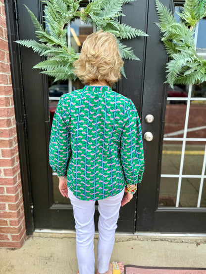 Lia Top: green patterned blouse with 3/4 puff sleeves, available in sizes XS-XL.