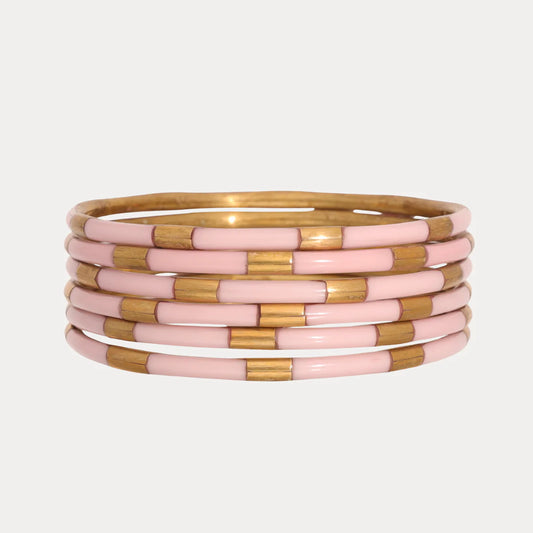 Six enamel bangles with alternating shiny gold and light pink segments. Available in small, medium, and large sizes.