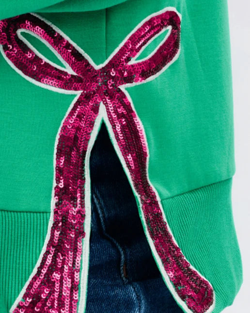 Lakelyn Green Bow Sweatshirt in green with a large fuchsia sequined bow appliqué on the side vent. Available in all sizes.