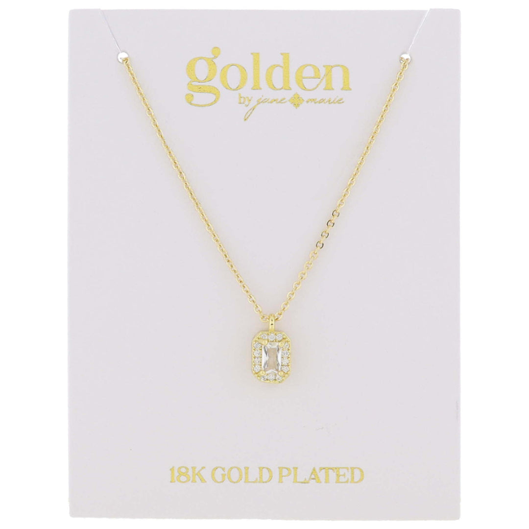 The product is a rectangular pendant featuring a clear, rectangular central stone. It hangs on a delicate chain labeled "18k gold plated" from "Golden by Jenny Marie." This pendant is part of the 18K Gold Plated with Mini Crystal Necklace collection.