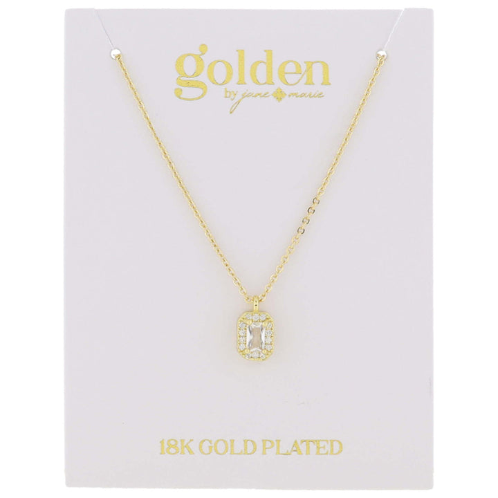 The product is a rectangular pendant featuring a clear, rectangular central stone. It hangs on a delicate chain labeled "18k gold plated" from "Golden by Jenny Marie." This pendant is part of the 18K Gold Plated with Mini Crystal Necklace collection.