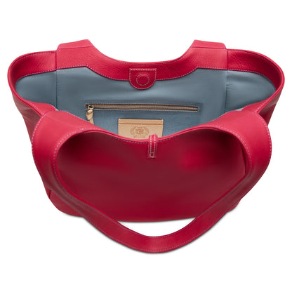 Red leather tote with heart-shaped opening, blue interior, zip pocket, red handles, button closure. Sizes: S/M/L.