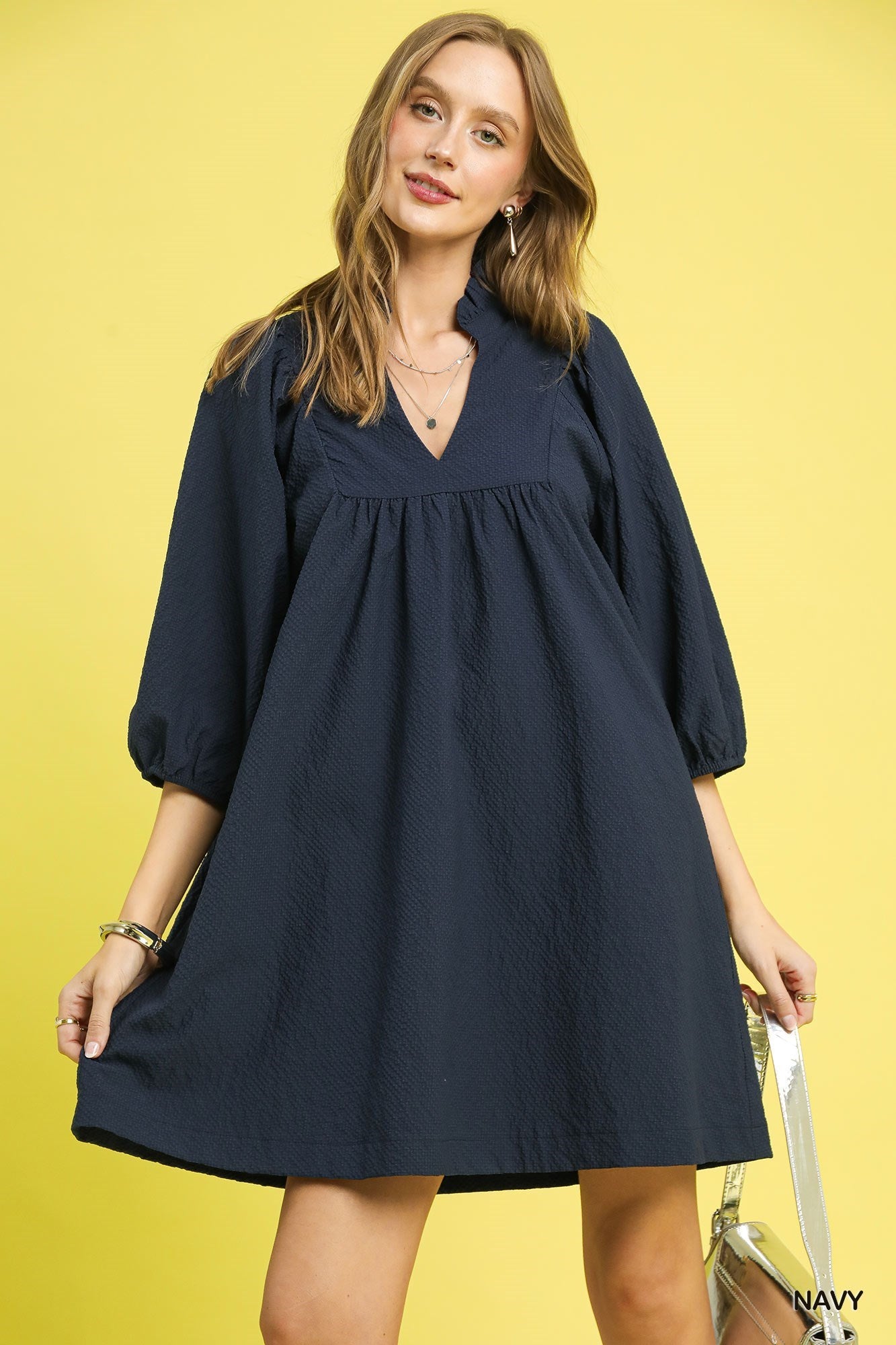 Textured Puff Sleeve Babydoll Dress in navy blue, loose fit, v-neckline, puffed sleeves. Available in sizes XS-XL.