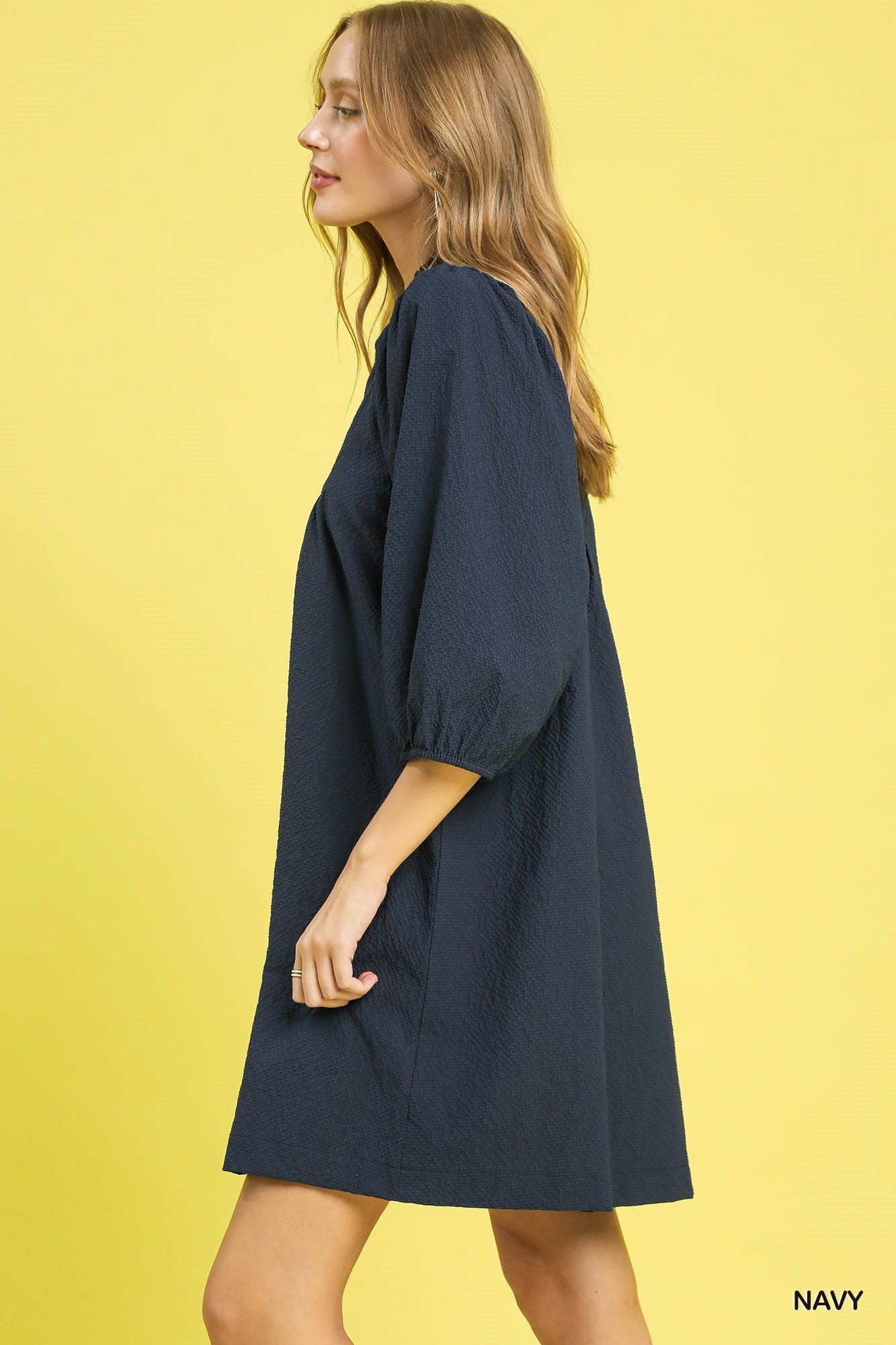 Textured Puff Sleeve Babydoll Dress in navy with three-quarter sleeves and relaxed fit. Available in XS–XL.