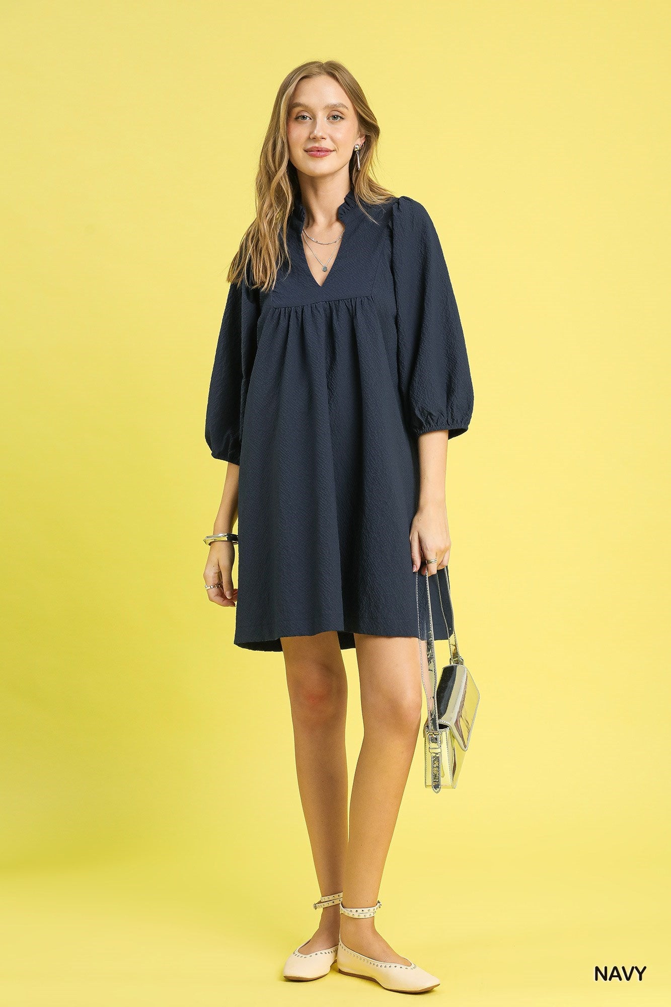 Textured Puff Sleeve Babydoll Dress in navy blue with three-quarter sleeves. Available in sizes XS-XL.
