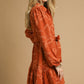 Rust Piper Jacquard Dress with Tie Waist. Available in sizes XS to XL.
