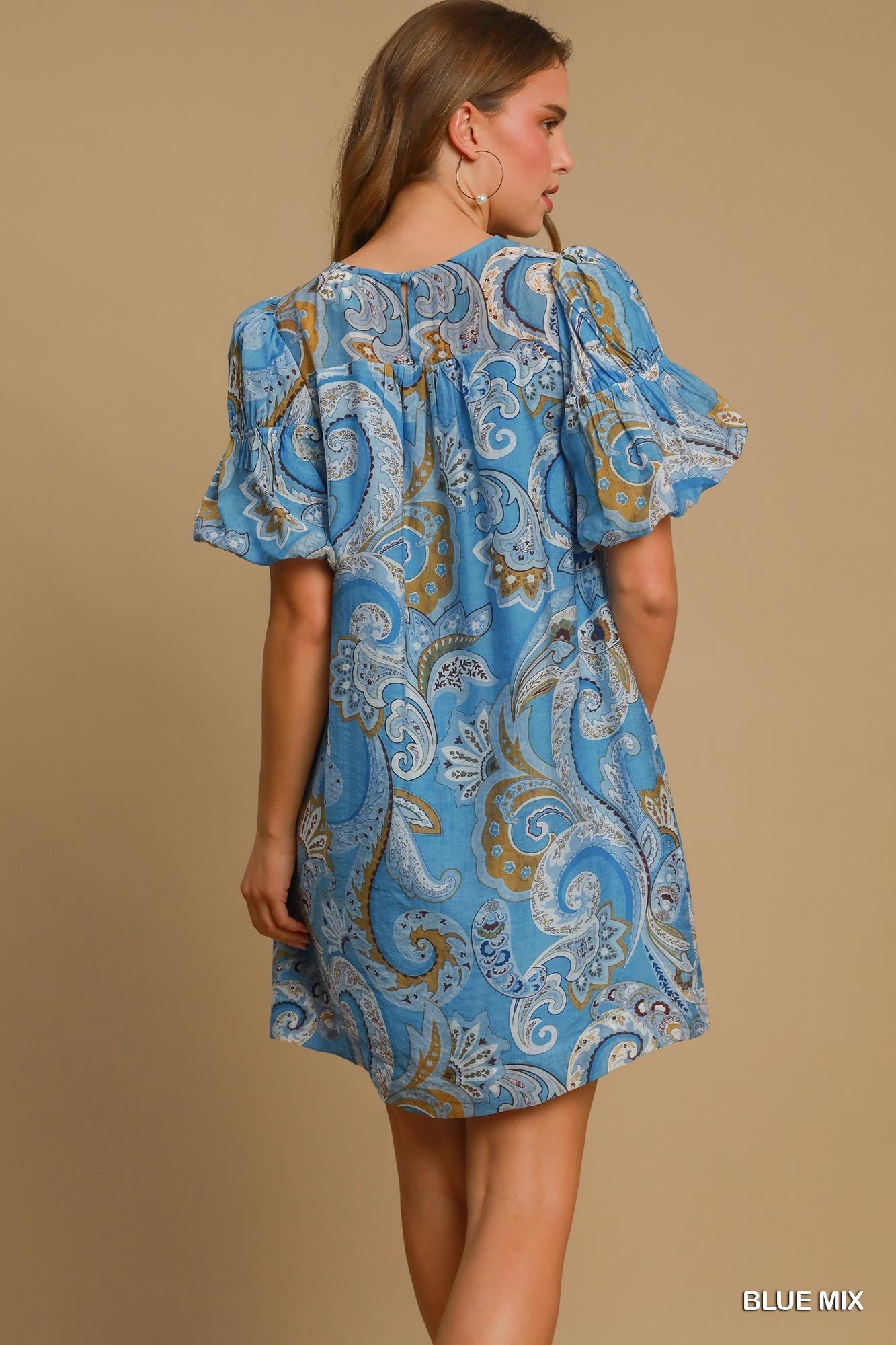 Paisley Blue Mix Babydoll Dress with ruffled short sleeves and blue prints. Available in sizes XS–XL. "BLUE MIX" text shown.