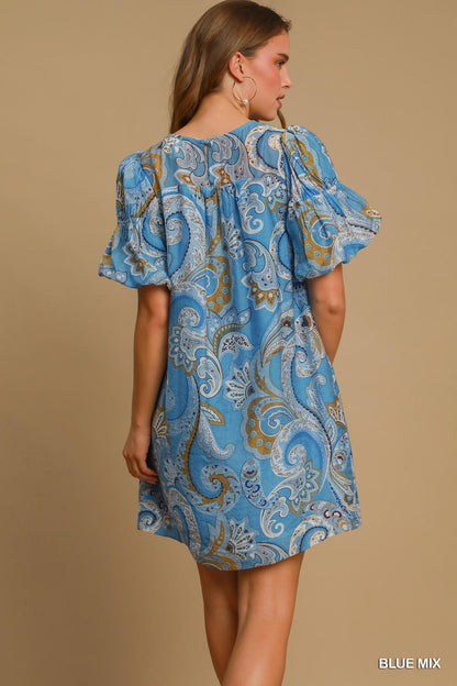 Paisley Blue Mix Babydoll Dress with ruffled short sleeves and blue prints. Available in sizes XS–XL. "BLUE MIX" text shown.