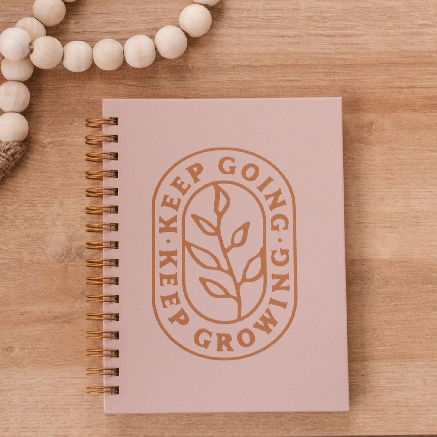Pink, scratch-resistant hardcover journal with lined pages, gold-embossed leaf, and inspiring text. Sizes available: standard.