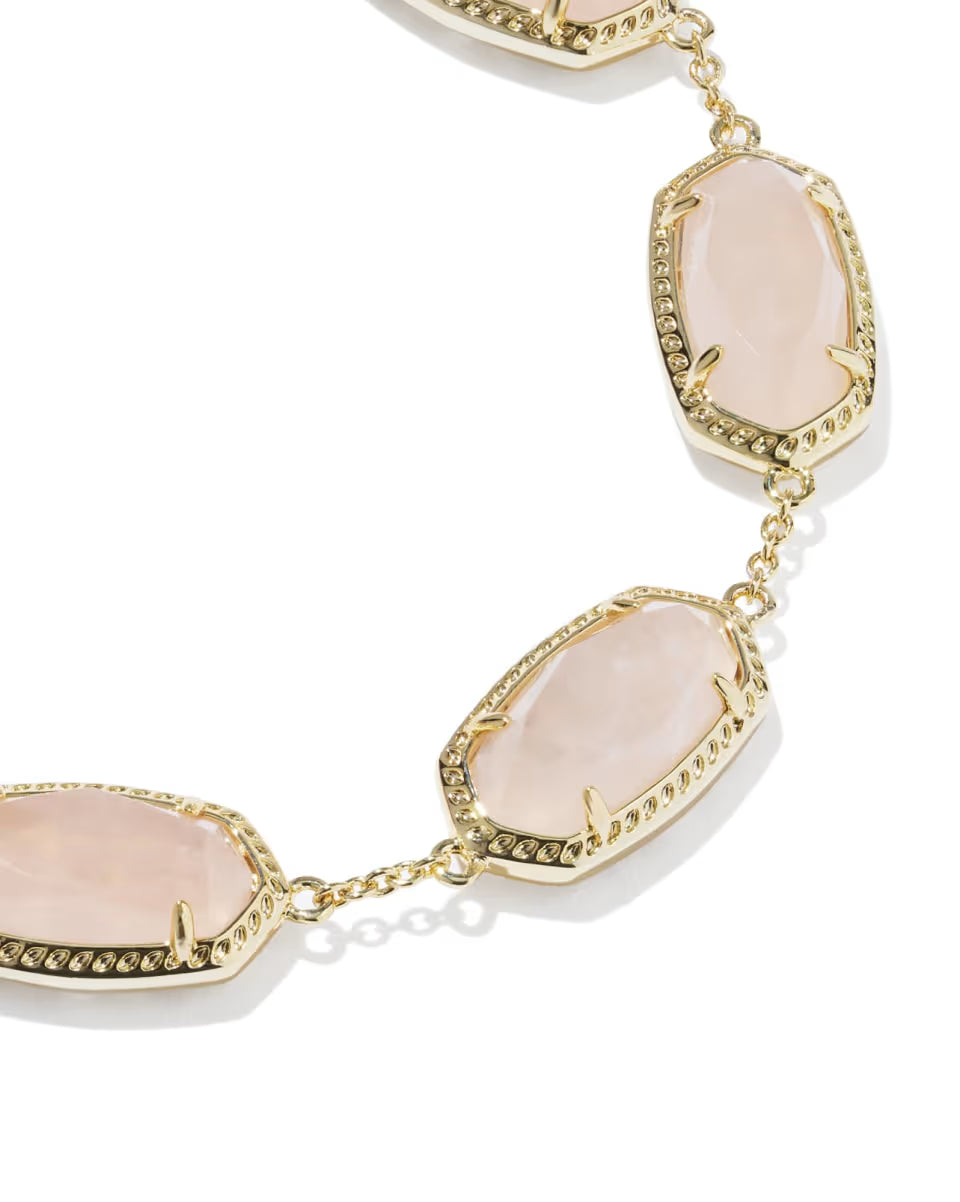 Elaina Gold Link Bracelet in Rose Quartz by Kendra Scott features three oval pale pink rose quartz stones in textured gold bezels. Available in one size: adjustable, fits most wrists.