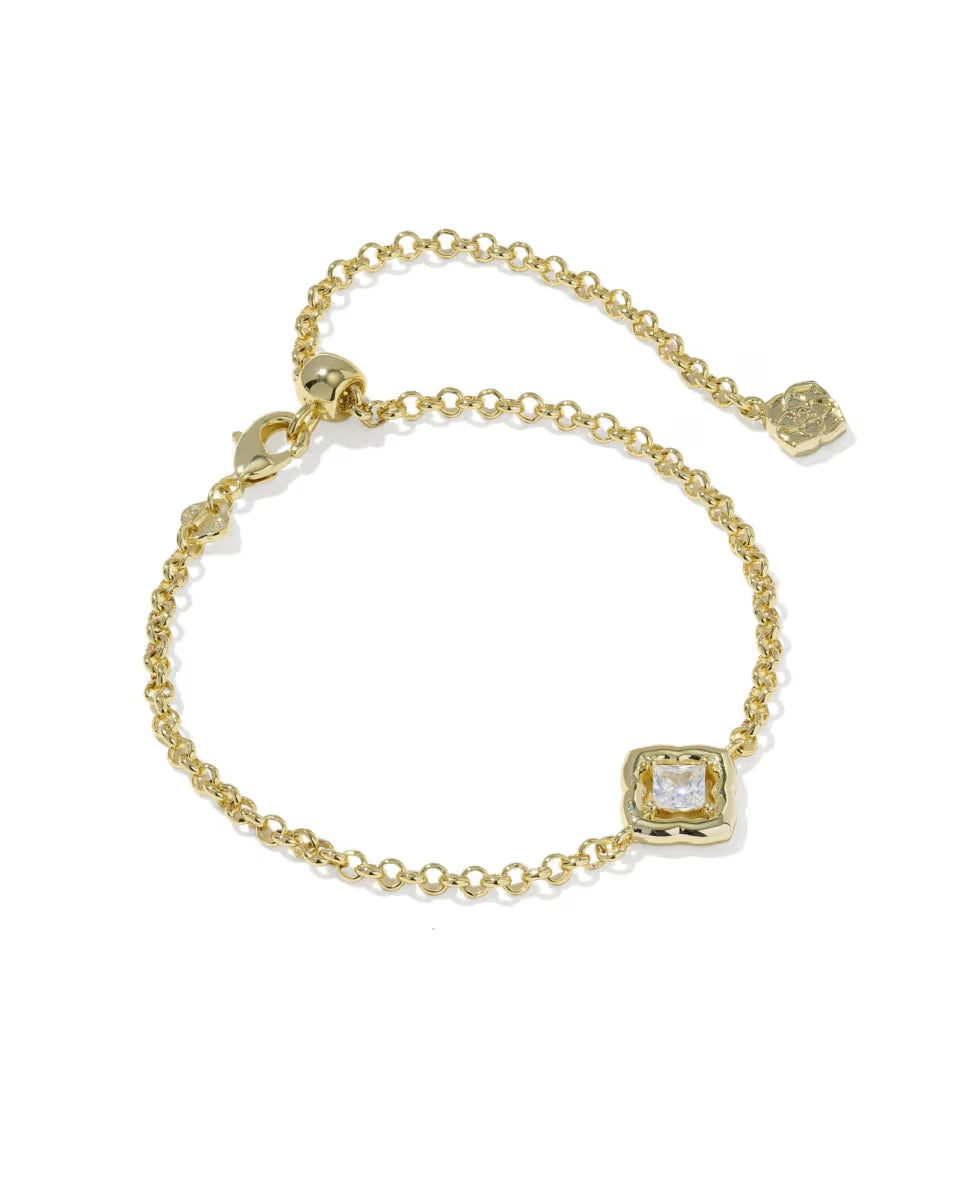 The Mallory Crystal Gold Delicate Chain Bracelet by Kendra Scott features a slim gold chain, adjustable clasp, and a square-cut clear crystal set in gold. Available in one size with adjustable fit.
