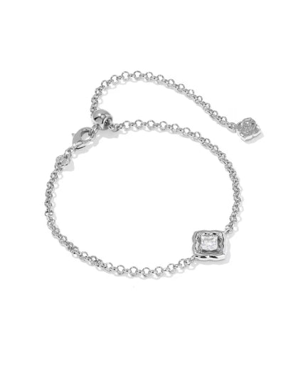 Silver-toned adjustable chain bracelet with a square white CZ gemstone centerpiece and a small charm near the clasp. Available in multiple sizes.