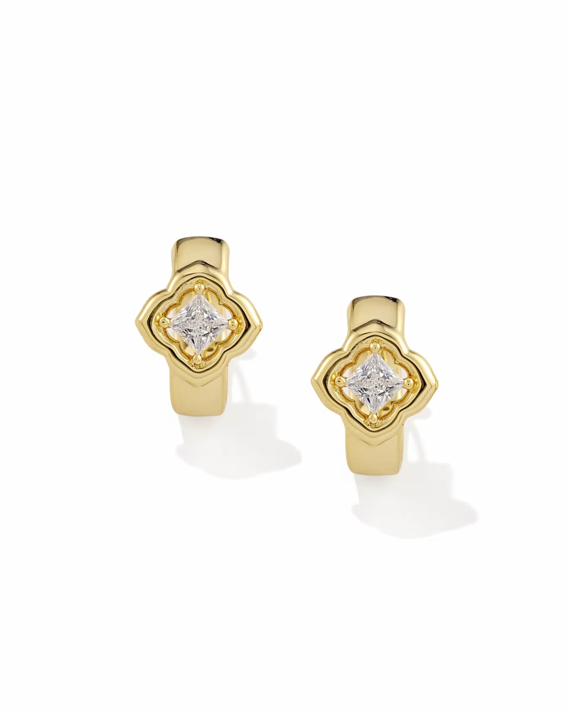 Gold huggie earrings with square white CZ gemstone in a clover-inspired setting at the center, available in multiple sizes.