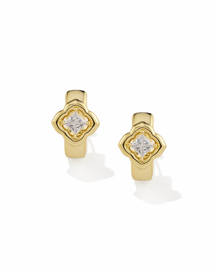 Gold huggie earrings with square white CZ gemstone in a clover-inspired setting at the center, available in multiple sizes.