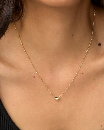 Mini Elisa Gold Satellite Short Pendant Necklace in Dichroic Glass by Kendra Scott with a delicate, oval-shaped pendant. Available in multiple lengths.