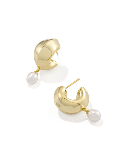 Gold huggie earrings with a single dangling freshwater cultured pearl on each hoop. Available in multiple sizes.
