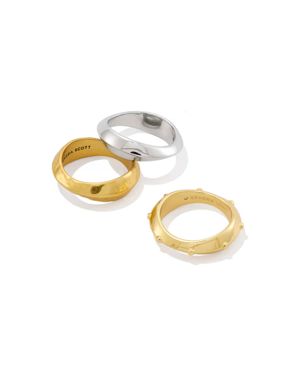 The Oakland Mixed Metal Ring Set of 3 by Kendra Scott includes two gold rings—one hammered, one smooth—and one smooth silver ring. Available in sizes 5–9.