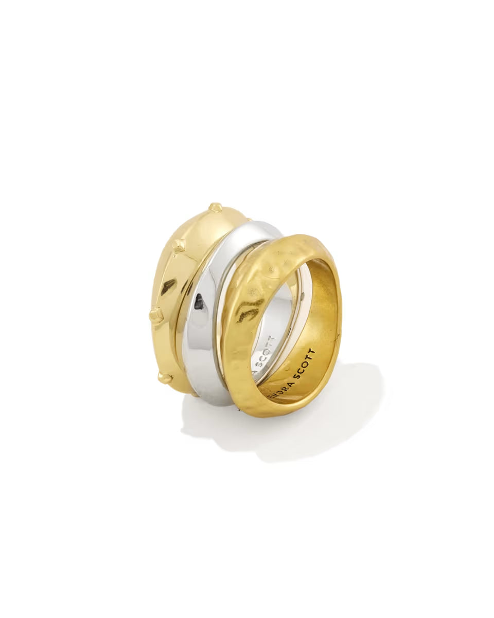 The Oakland Mixed Metal Ring Set of 3 by Kendra Scott features two gold bands—one hammered, one with raised dot details—and one polished silver band. Available in sizes 5-9.