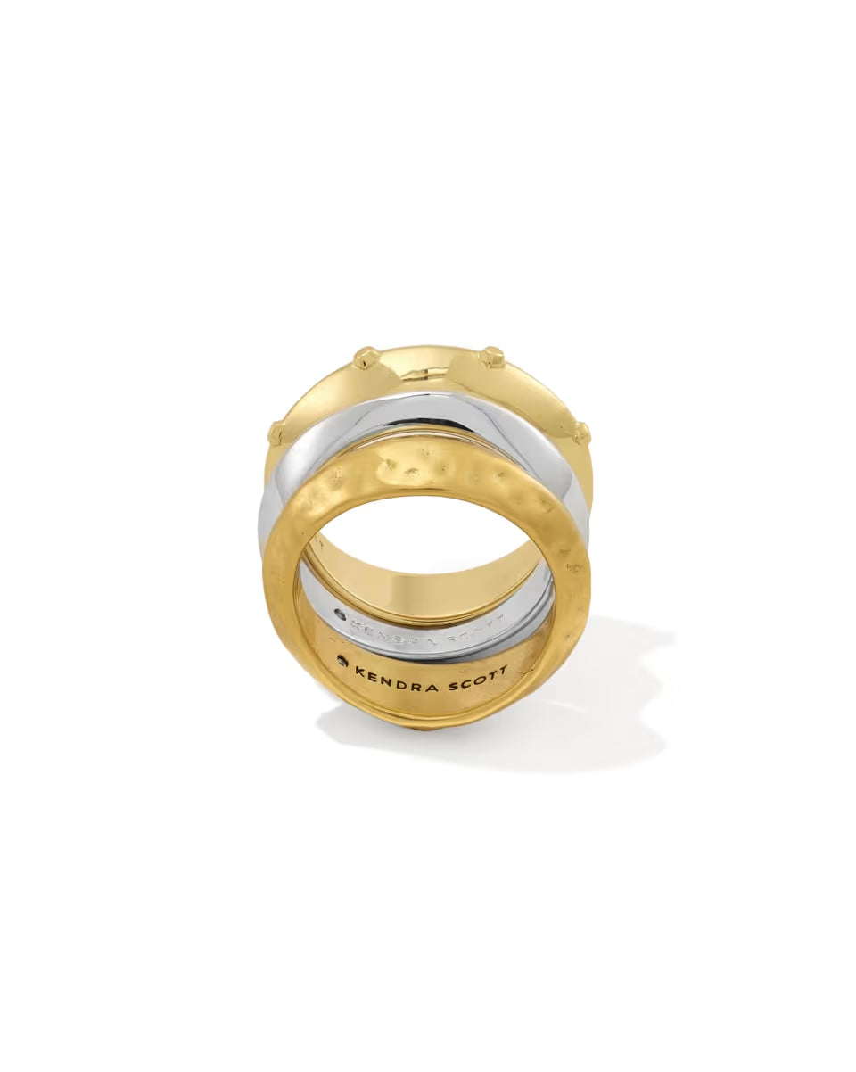 Oakland Mixed Metal Ring Set of 3 by Kendra Scott includes gold and silver stackable bands with hammered and smooth textures; bottom band engraved with “KENDRA SCOTT.” Available in sizes 5-9.