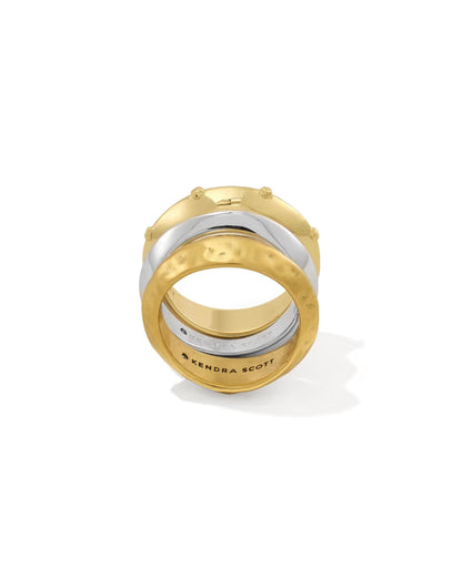 Oakland Mixed Metal Ring Set of 3 by Kendra Scott includes gold and silver stackable bands with hammered and smooth textures; bottom band engraved with “KENDRA SCOTT.” Available in sizes 5-9.