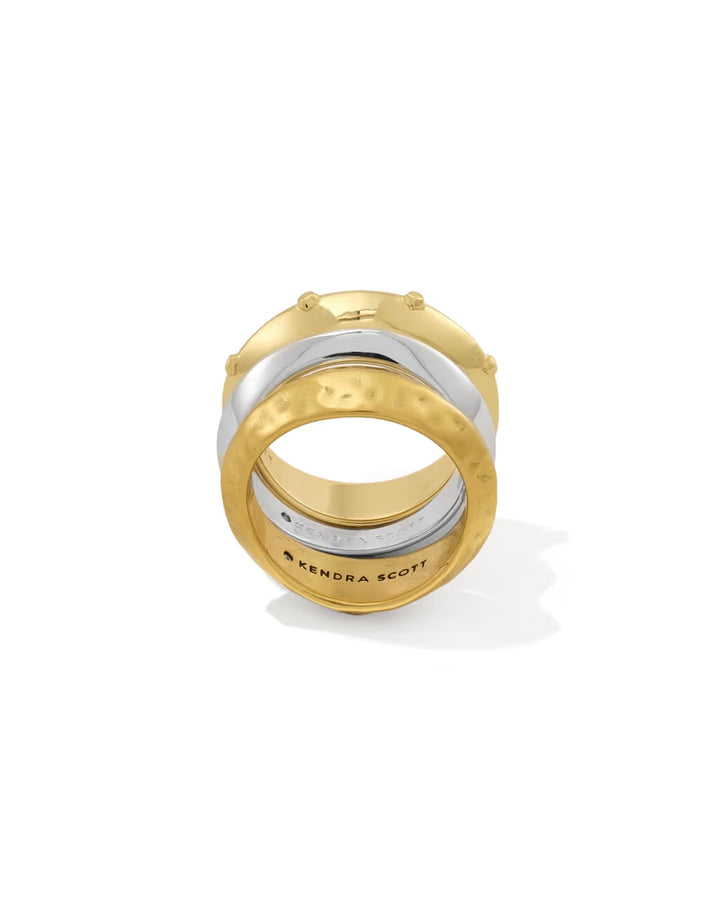 Oakland Mixed Metal Ring Set of 3 by Kendra Scott includes gold and silver stackable bands with hammered and smooth textures; bottom band engraved with “KENDRA SCOTT.” Available in sizes 5-9.