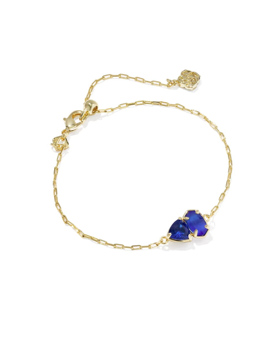 Tatum Gold Delicate Chain Bracelet in Cobalt Mix by Kendra Scott features a gold chain, heart-shaped deep blue gemstone, petite white pearl accent, and secure lobster clasp. Available sizes: 6.5″, 7″, and 7.5″.