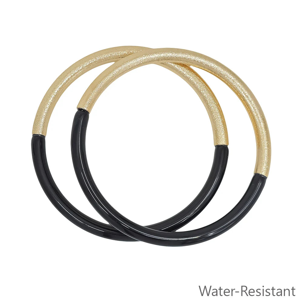 Leo Resin Gold Bangle Bracelet Set includes two intertwined bangles with gold on the top half and black resin on the bottom half. Water-resistant. Available sizes: S, M, L.