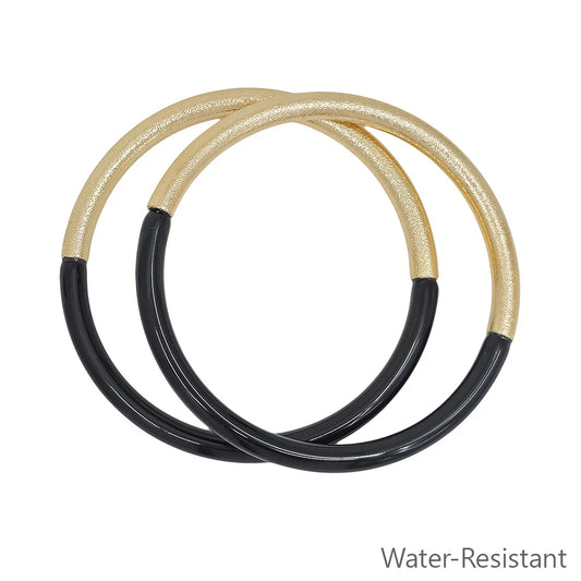Leo Resin Gold Bangle Bracelet Set includes two intertwined bangles with gold on the top half and black resin on the bottom half. Water-resistant. Available sizes: S, M, L.