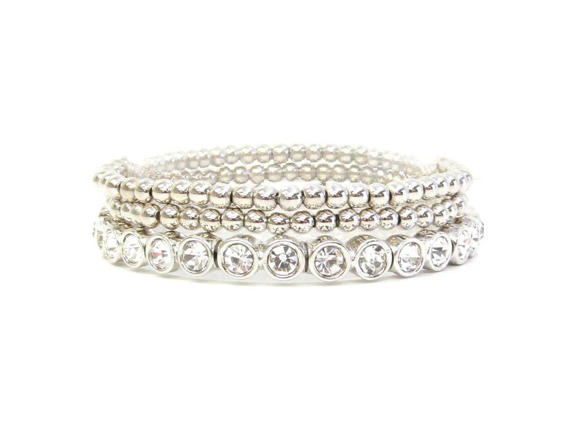 Three silver beaded stretch bracelets with clear round gemstones on one strand; available in multiple sizes.