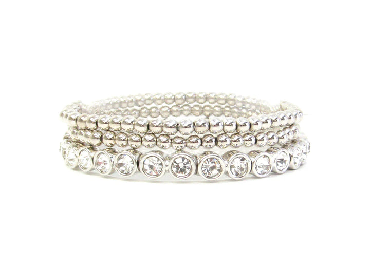 Three silver beaded stretch bracelets with clear round gemstones on one strand; available in multiple sizes.