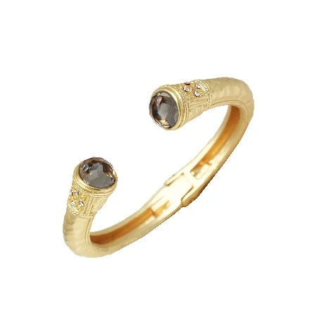 The Meg Black Diamond Hinge Cuff Bracelet is a gold open cuff with round black diamond stones and clear accents at each end, featuring detailed settings. Available in small, medium, and large sizes.