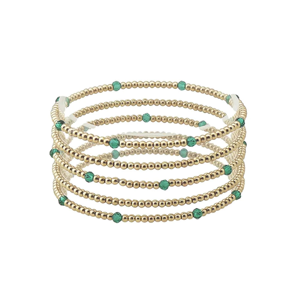 Set of seven thin gold and colored bead stretch bracelets with evenly spaced small turquoise beads, available in one size.