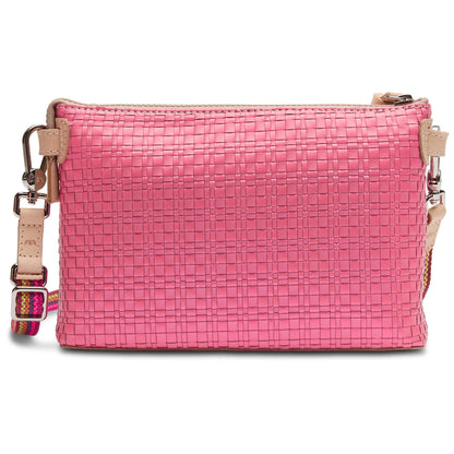 The Midtown Crossbody, Pink: small woven-texture bag with beige leather accents, zipper closure, and adjustable strap featuring a colorful woven pattern. Available sizes: Small, Medium.