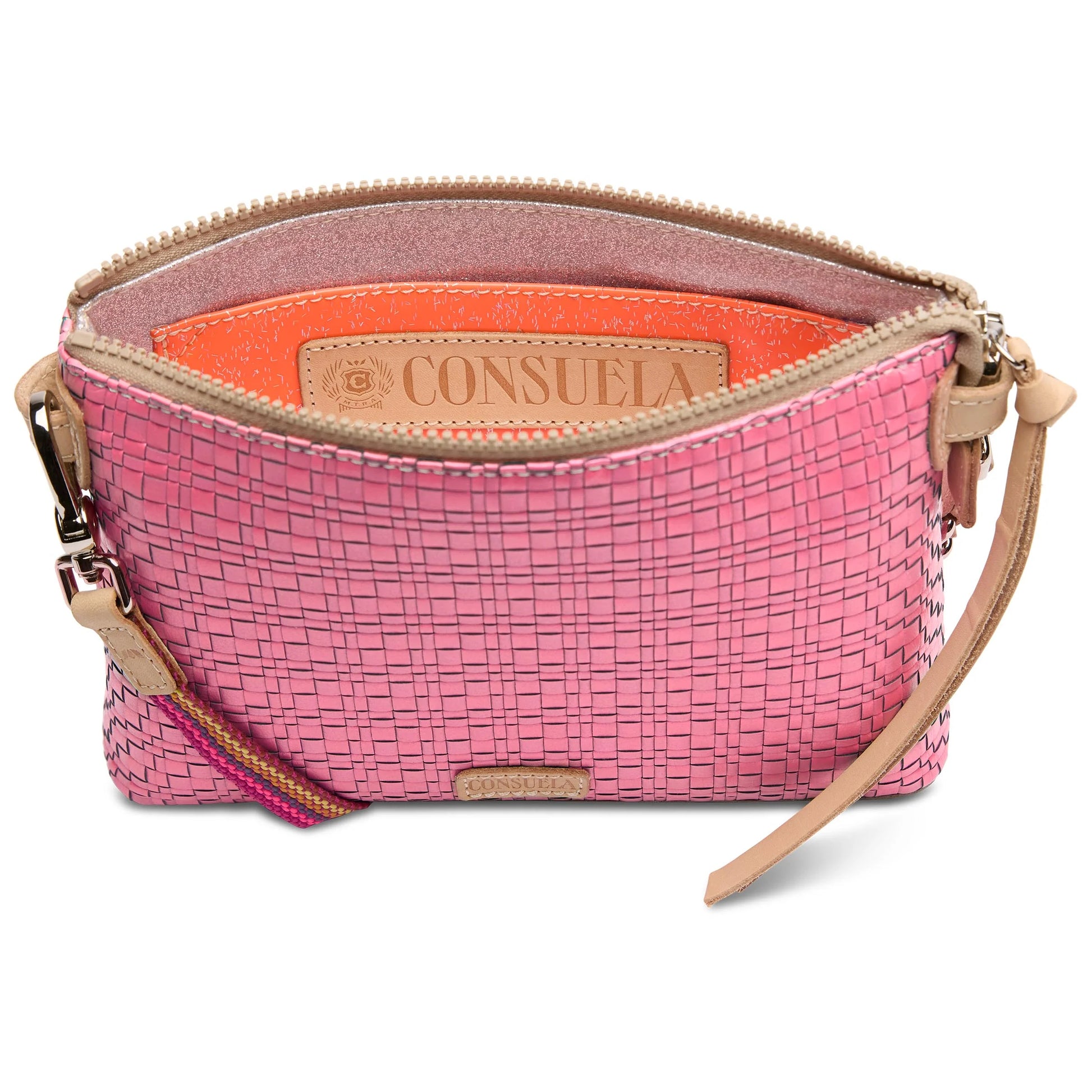 The Midtown Crossbody, Pink: Chic pink woven texture, tan zipper and wrist strap, orange interior, leather "Consuela" embossed label. Sizes available: 9” L x 6” H x 1¼” D; adjustable and removable crossbody strap (22½” drop); detachable wristlet strap.