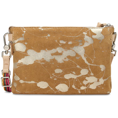 Tan suede crossbody bag with white paint splatter, silver zipper, light tan leather pull, and colorful striped adjustable strap. Available sizes: small, medium, large.