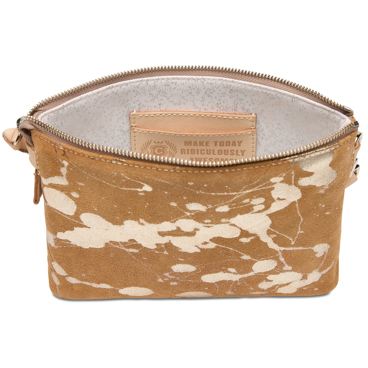 The Midtown Crossbody in Marlow is a tan suede bag with a white abstract splatter pattern, light interior, leather patch reading “MAKE TODAY RIDICULOUSLY,” and an adjustable strap. Available in one size.
