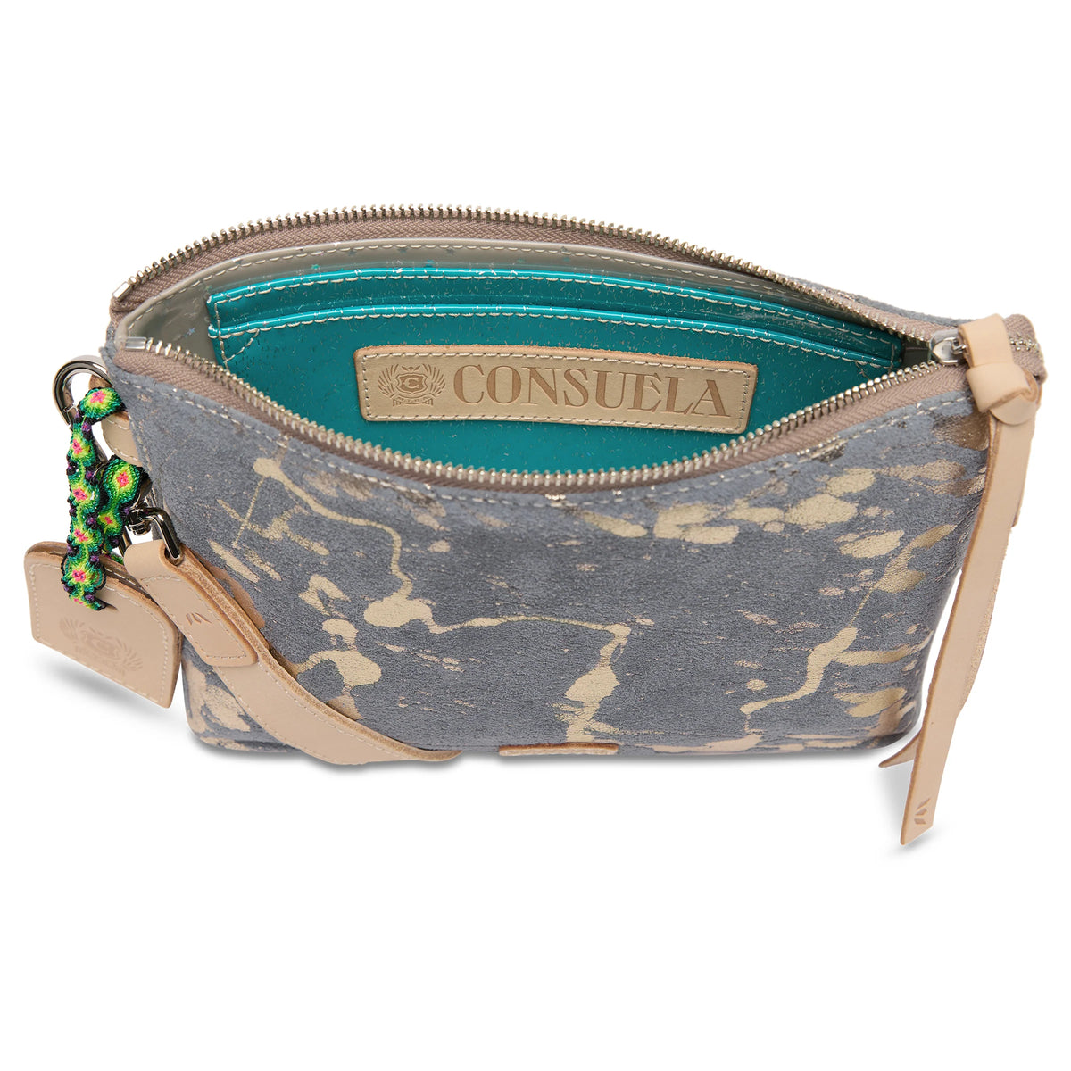 Gray and beige splatter pattern crossbody with tan leather zipper pull, turquoise interior, attached keychain accessories, and detachable strap. Available in one size.