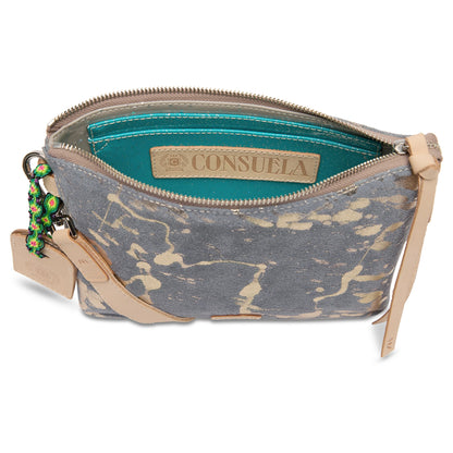Gray and beige splatter pattern crossbody with tan leather zipper pull, turquoise interior, attached keychain accessories, and detachable strap. Available in one size.