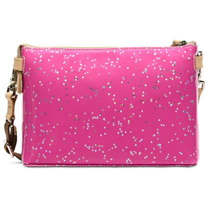 Midtown Crossbody in Berry: vibrant pink glitter bag with silver and white star accents, gold zipper and strap details, adjustable strap. Available in small, medium, and large sizes.